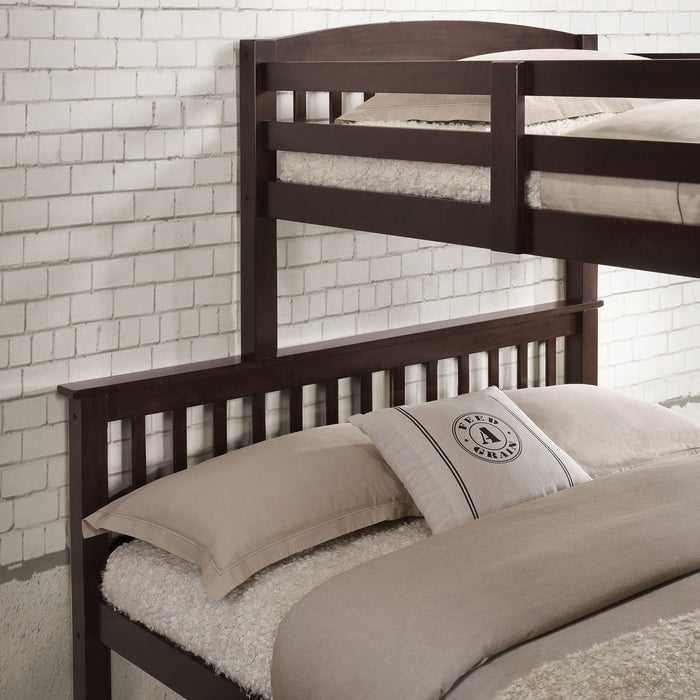 Left facing close up of the headboards of a Mission style twin-over-full dark brown wood bunk bed in a room with linens