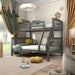 Left facing Mission style twin-over-full grey wood bunk bed in a room with linens and accessories