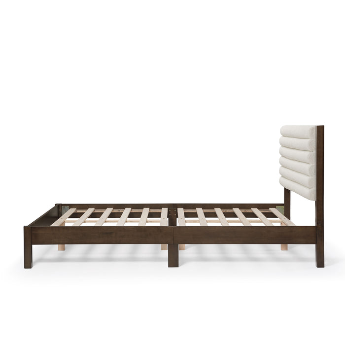 Front facing side view of a modern dark walnut wood frame queen platform bed with a channel tufted upholstered white boucle headboard on a white background