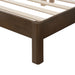 Left facing close up corner leg view of a modern dark walnut wood frame queen platform bed with a channel tufted upholstered white boucle headboard on a white background