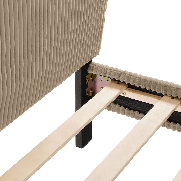 Right facing close up view of the headboard corner and slats of a modern light brown corduroy channel tufted headboard queen platform bed on a white background