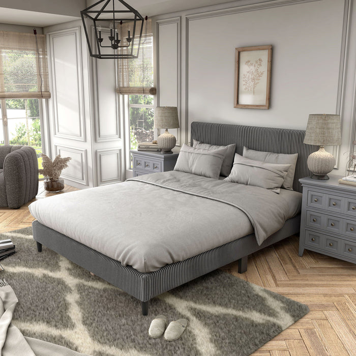 Left facing modern dark grey corduroy channel tufted headboard queen platform bed in a room with linens and accessories