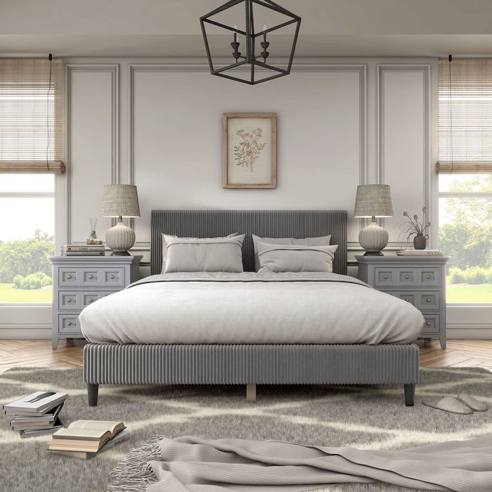 Front facing modern dark grey corduroy channel tufted headboard queen platform bed in a room with linens and accessories