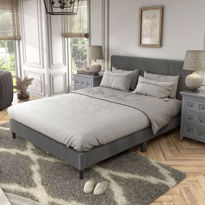 Left facing modern dark grey corduroy channel tufted headboard queen platform bed in a room with linens and accessories