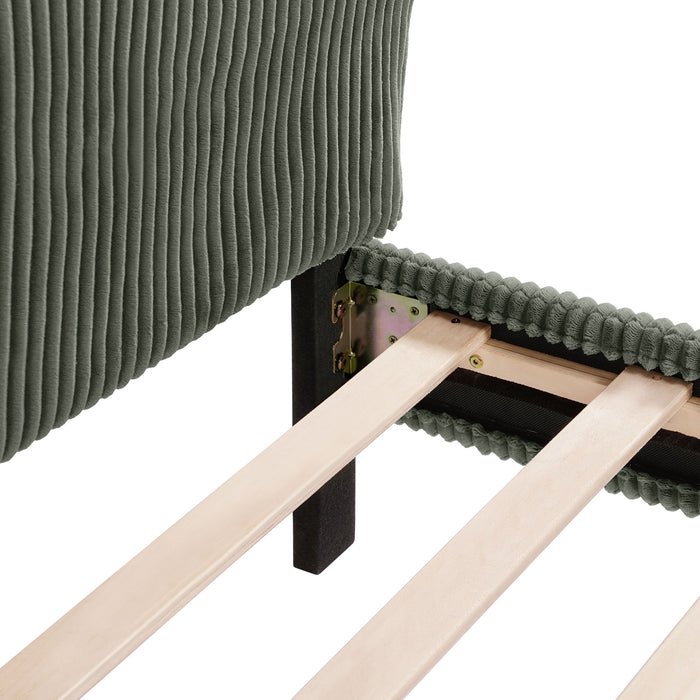 Right facing close up view of the headboard corner and slats of a modern green corduroy channel tufted headboard queen platform bed on a white background