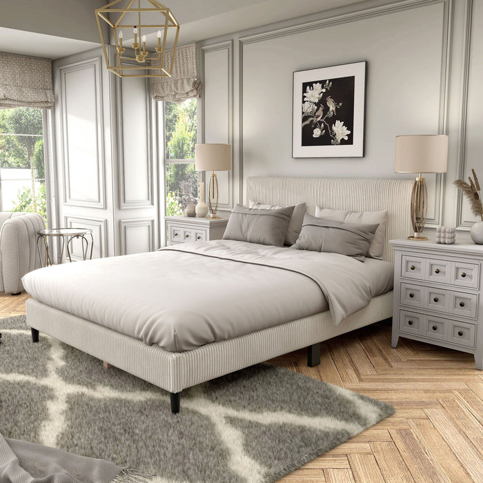 Left facing modern ivory corduroy channel tufted headboard queen platform bed in a room with linens and accessories