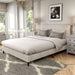 Left facing modern ivory corduroy channel tufted headboard queen platform bed in a room with linens and accessories