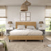 Front facing modern yellow corduroy channel tufted headboard queen platform bed in a room with linens and accessories