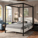 Left facing modern black finish queen canopy platform bed with white boucle upholstery in a room with linens and accessories