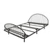 Left facing industrial black metal full bed frame with rounded head and footboards on a white background