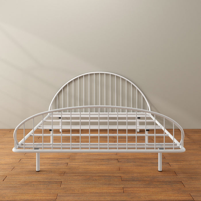 Front facing industrial white metal queen bed frame with rounded head and footboards in a room with a wood floor