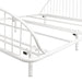 Left facing close up view of an industrial white metal queen bed frame with rounded head and footboards on a white background