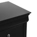 Right facing close up of a traditional black finish solid wood two-drawer nightstand showing its molded trim and tabletop, on a white background