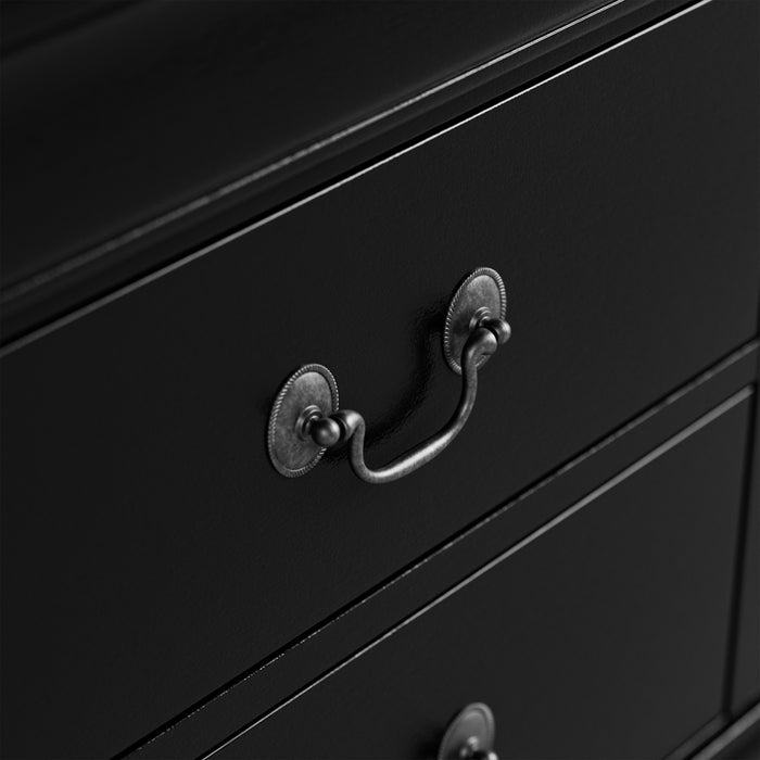 Right facing close up of a traditional black finish solid wood five-drawer chest showing its hanging drawer pulls