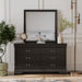 Front facing traditional black finish solid wood six-drawer dresser with a framed mirror in a room with accessories