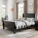 Left facing traditional black finish solid wood full sleigh bed in a room with linens and accessories