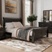 Left facing traditional black finish solid wood queen sleigh bed in a room with linens and accessories