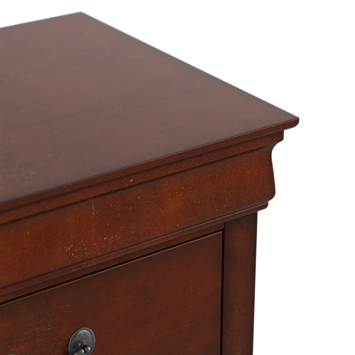 Right facing close up of a traditional cherry finish solid wood five-drawer chest showing its molded trim and tabletop, on a white background