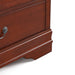 Right facing close up of a traditional cherry finish solid wood six-drawer dresser with a framed mirror showing its lower molded trim and bracket foot, on a white background