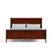 Front facing traditional cherry finish solid wood king sleigh bed with linens on a white background