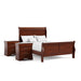 Right facing three-piece traditional cherry finish solid wood full bedroom set with (1) full sleigh bed and (2) two-drawer nightstands on a white background