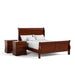 Right facing three-piece traditional cherry finish solid wood queen bedroom set with (1) queen sleigh bed and (2) two-drawer nightstands on a white background