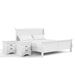 Right facing three-piece traditional white finish solid wood king bedroom set with (1) king sleigh bed and (2) two-drawer nightstands on a white background