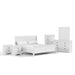 Right facing six-piece traditional white finish solid wood eastern king bedroom set with (1) sleigh bed, (2) two-drawer nightstands, (1) five-drawer chest, (1) six-drawer dresser, and (1) mirror on a white background