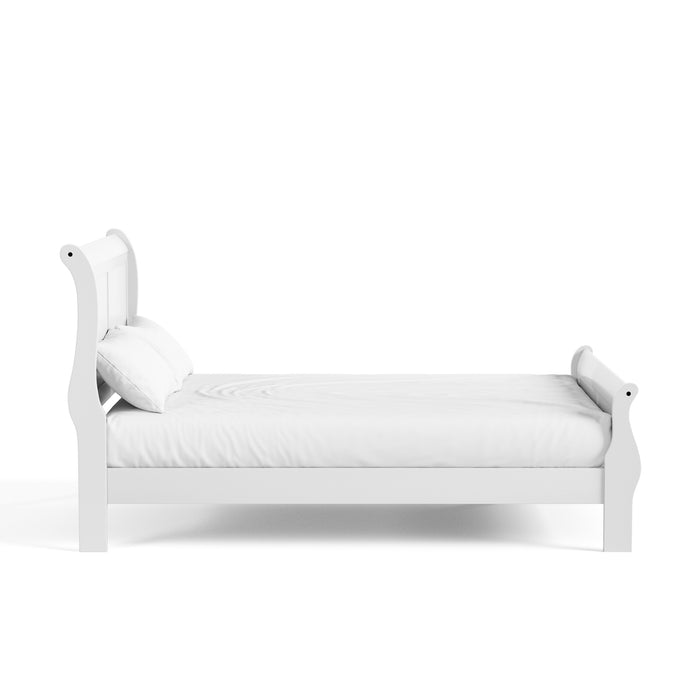 Front facing side view of a traditional white finish solid wood full bed with linens on a white background