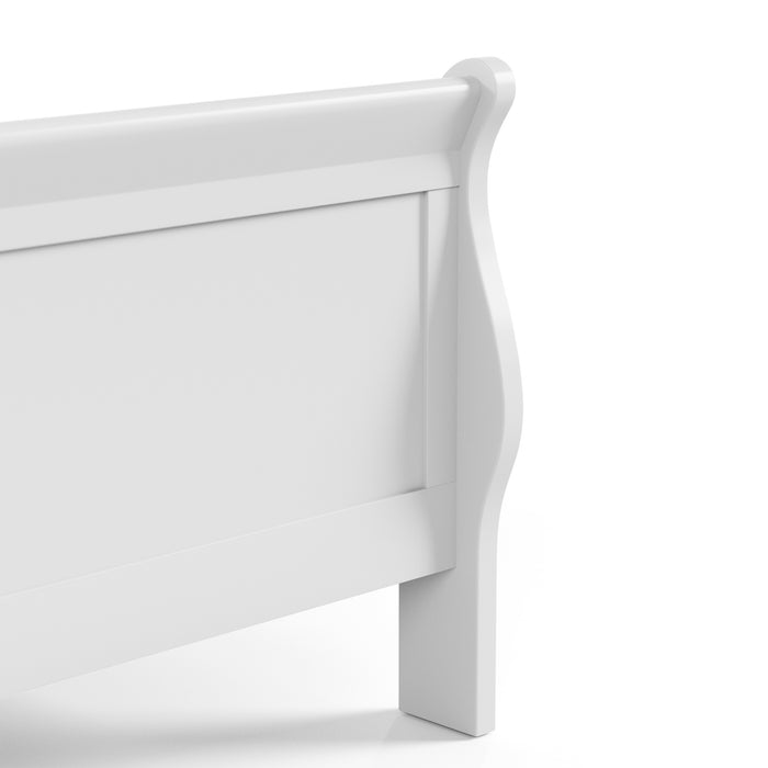 Right facing close up view of a traditional white finish solid wood queen sleigh bed showing its footboard, on a white background