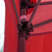 Close up view of the frame of a modern red portable camping gazebo canopy with roof and anchors