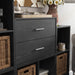 Right facing modern two-drawer black storage cabinet with silver handles in a larger modular bookcase with accessories