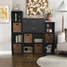 Front facing modern two-drawer black storage cabinet with silver handles in a larger modular bookcase with accessories