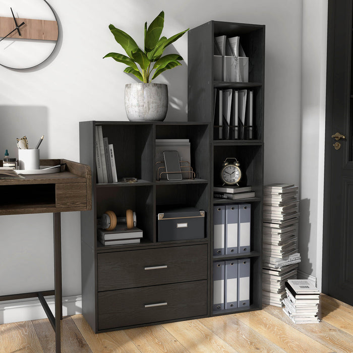 Left facing durable modern four-cubby black storage bookcase as part of a larger modular configuration in a room with accessories