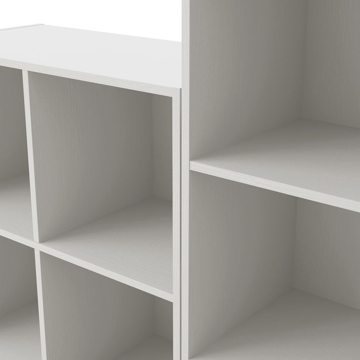 Close up view of a modern white modular bookcase system with open shelving on a white background