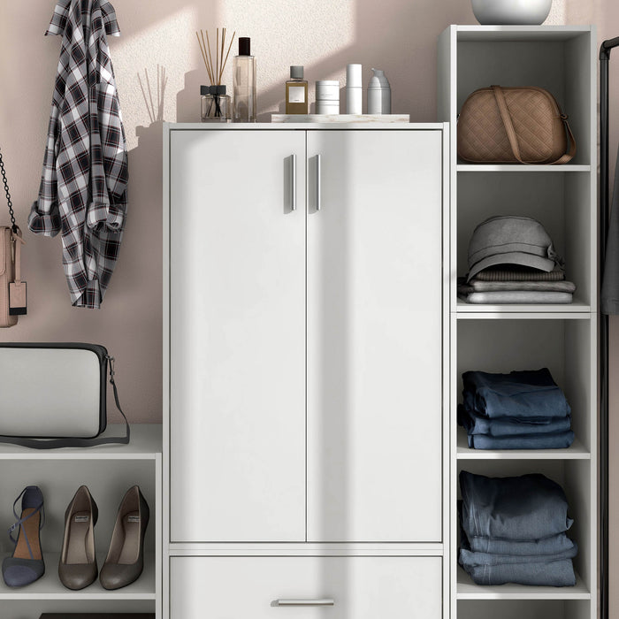 Front facing durable modern two-door white storage cabinet with silver handles as part of a larger modular configuration in a room with accessories