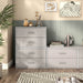 Front facing modern two-drawer taupe grey storage cabinet with silver handles in a larger modular bookcase with accessories