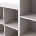 Close up view of a durable modern two-shelf taupe grey storage bookcase in a larger modular configuration on a white background