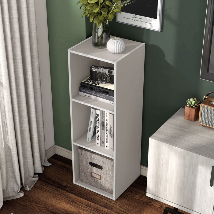 Left facing high-camera view of a durable modern three-shelf slim taupe grey storage bookcase in a room with accessories