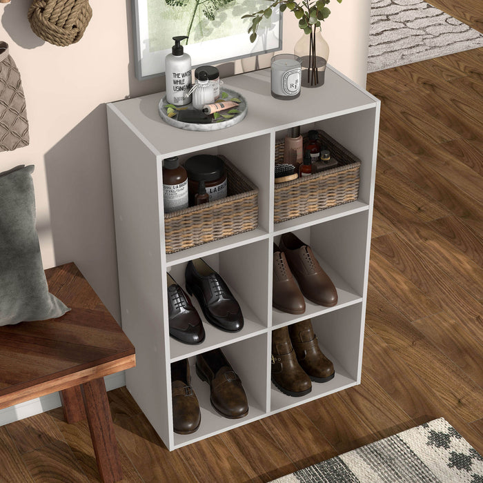 Right facing high-camera view of a durable modern six-cubby taupe grey storage bookcase in a room with accessories