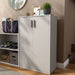 Left facing durable modern two-door taupe grey storage cabinet with silver handles as part of a larger modular configuration in a room with accessories