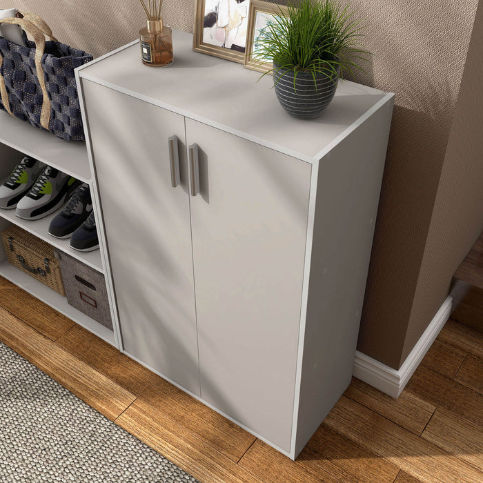 Left facing high-camera view of a durable modern two-door taupe grey storage cabinet with silver handles as part of a larger modular configuration in a room with accessories