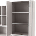 Left facing durable modern two-door taupe grey storage cabinet with silver handles with doors open as part of a larger modular configuration on a white background