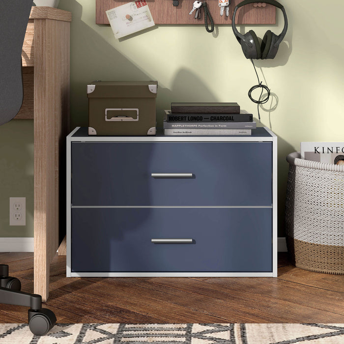 Front facing modern two-drawer steel blue storage cabinet with silver handles in room with accessories