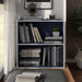 Front facing durable modern two-shelf steel blue storage bookcase in a larger modular configuration in a room with accessories