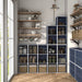 Front facing durable modern three-shelf slim steel blue storage bookcase in a larger modular configuration in a room with accessories