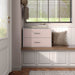 Front facing modern two-drawer light pink storage cabinet with silver handles in room with accessories