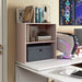 Right facing durable modern two-shelf light pink storage bookcase in a larger modular configuration in a room with accessories