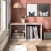 Front facing durable modern two-shelf slim light pink bookcase in a room with accessories