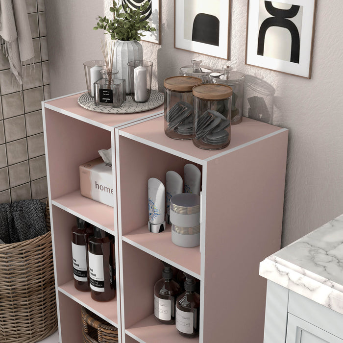 Left facing high-camera view of a durable modern three-shelf slim light pink storage bookcase in a larger modular configuration in a room with accessories